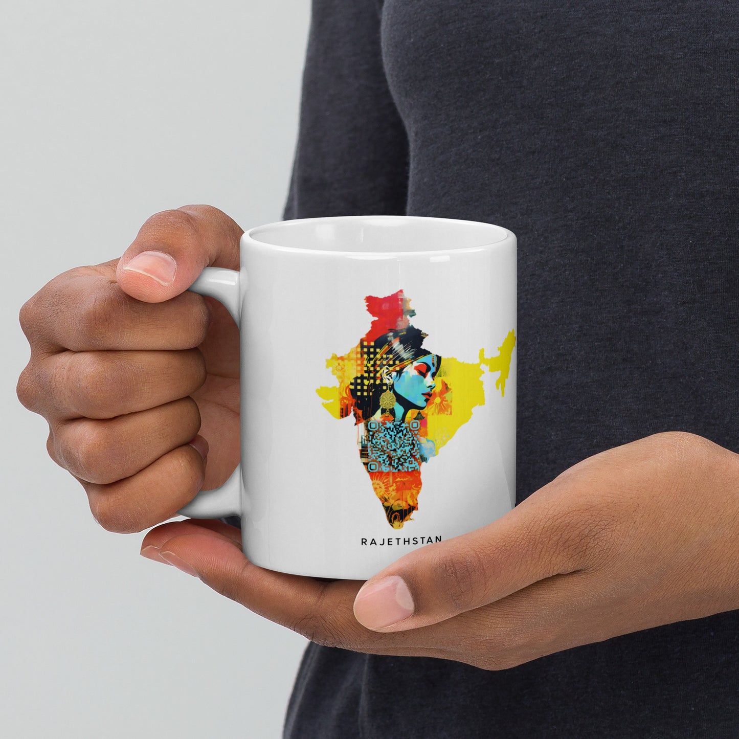 A white 11 oz mug displaying an intricate map of India, complemented by a digitally constructed image of a Rajasthan woman in traditional attire, infused with azure-and-amber hues. The design, inspired by Joram Roukes and dadaist photomontage, blends Afrofuturism with multi-colored minimalism, showcasing Rajasthan's rich culture.