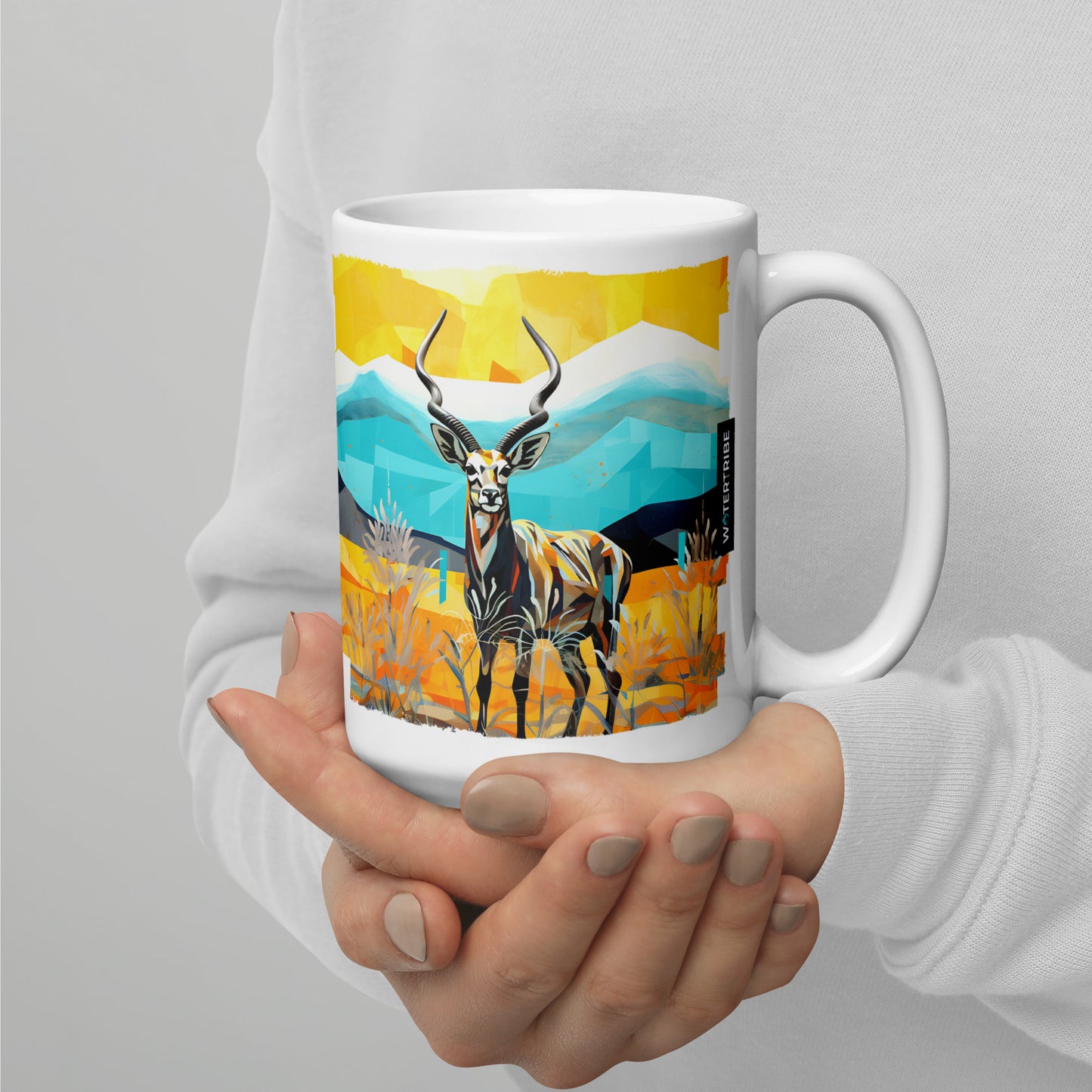 Experience the Kenyan Kaleidoscope Mug - 15oz, where a woman's hand cradles a mug with a striking deer image. This larger mug, designed in the style of bold and colorful graphic design, realistic landscapes, and desertwave influences, is a perfect choice for those who appreciate artistry and ample capacity.